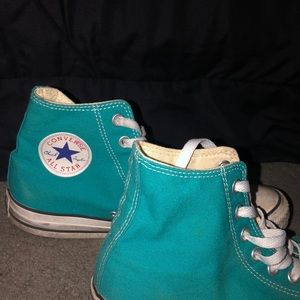 Teal high top Converse.